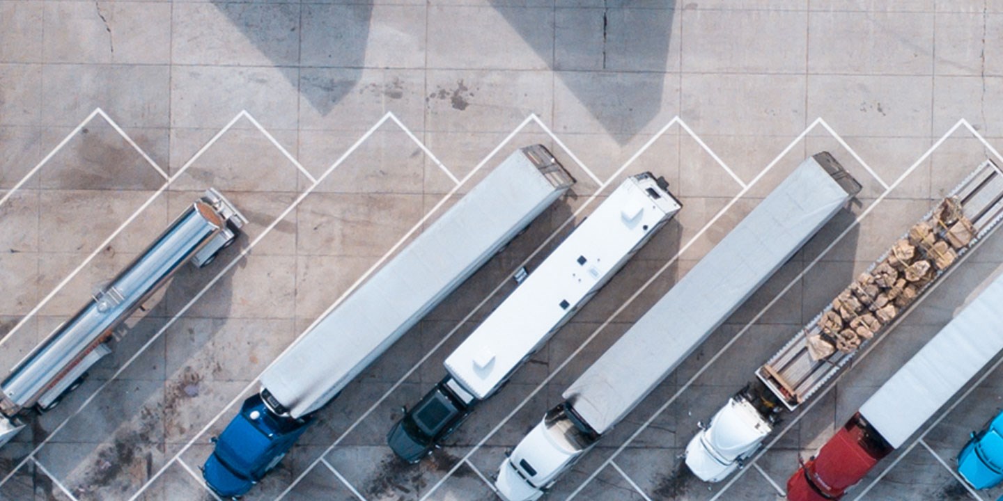 trucks parked at a rest stop, representing the supply chain process and supply chain management